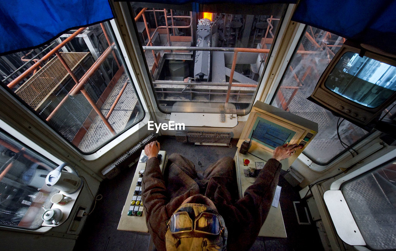 Directly above shot of man working in steel factory