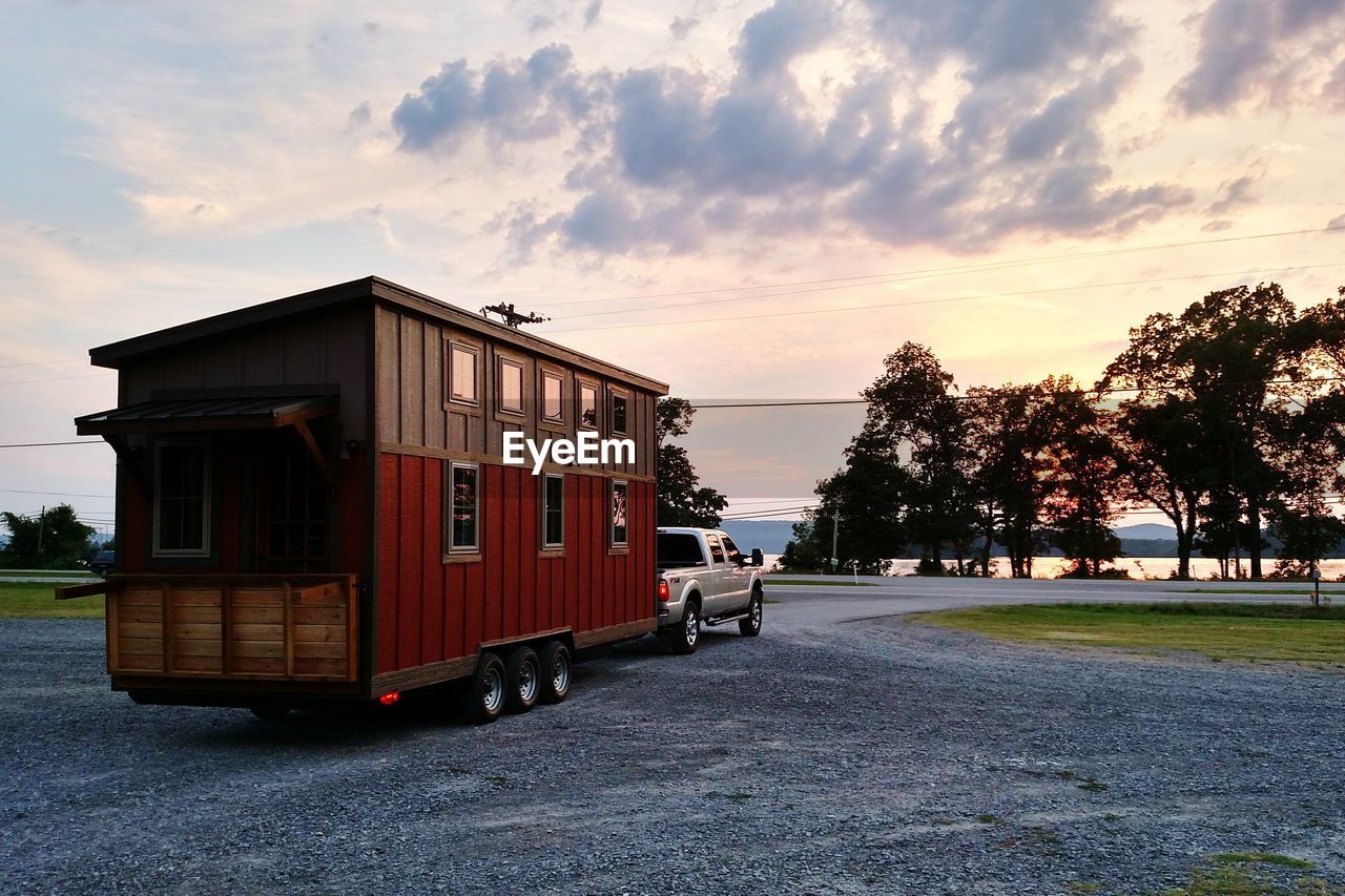 Trailer home on road at sunset