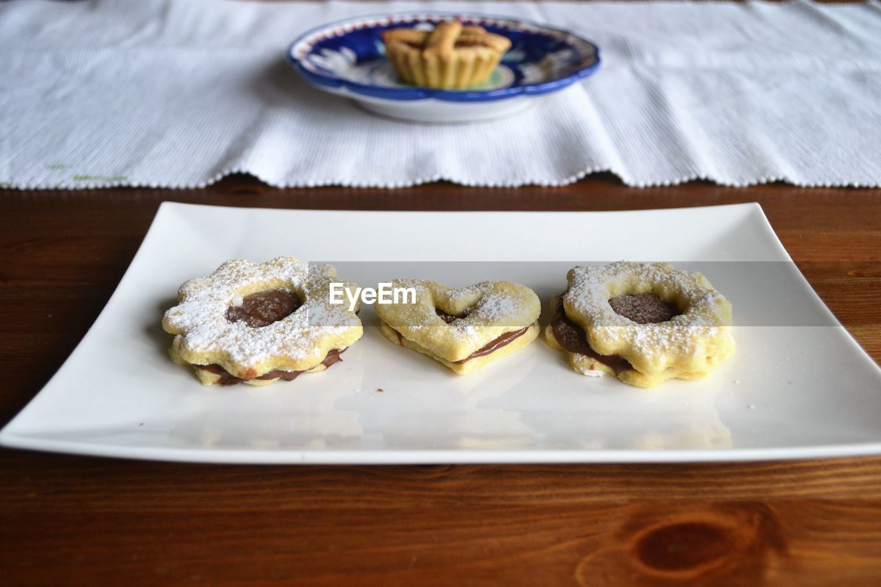 Cookies in plate on wooden table