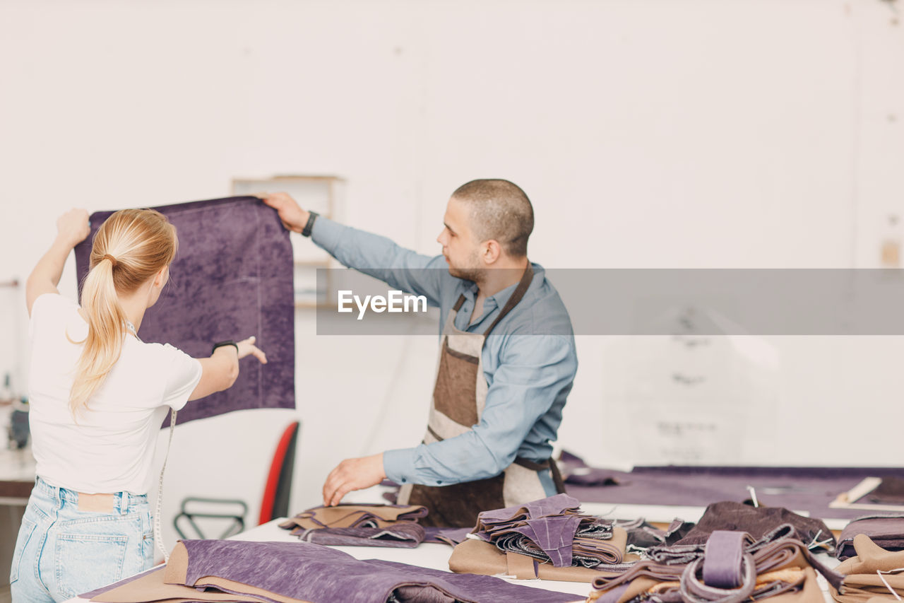 side view of man working at table