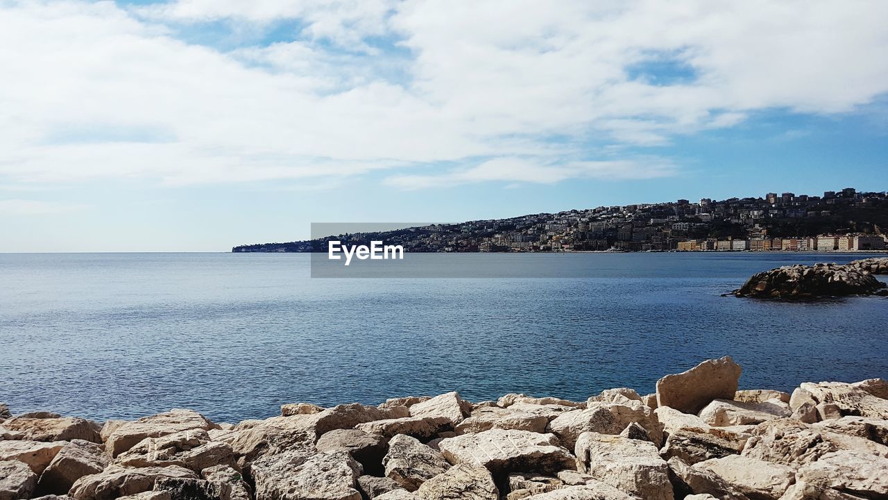 SCENIC VIEW OF SEA AND ROCKS AGAINST SKY