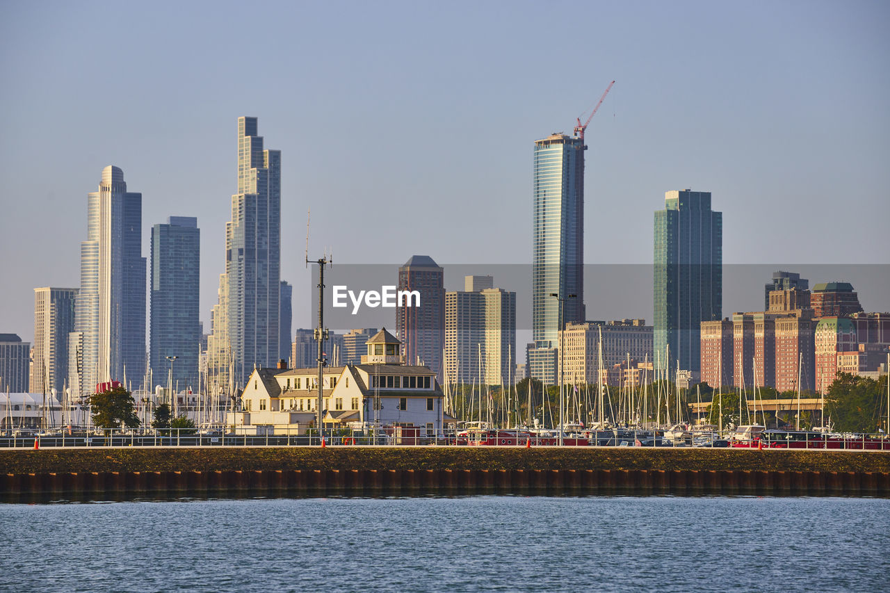 city at waterfront against clear sky