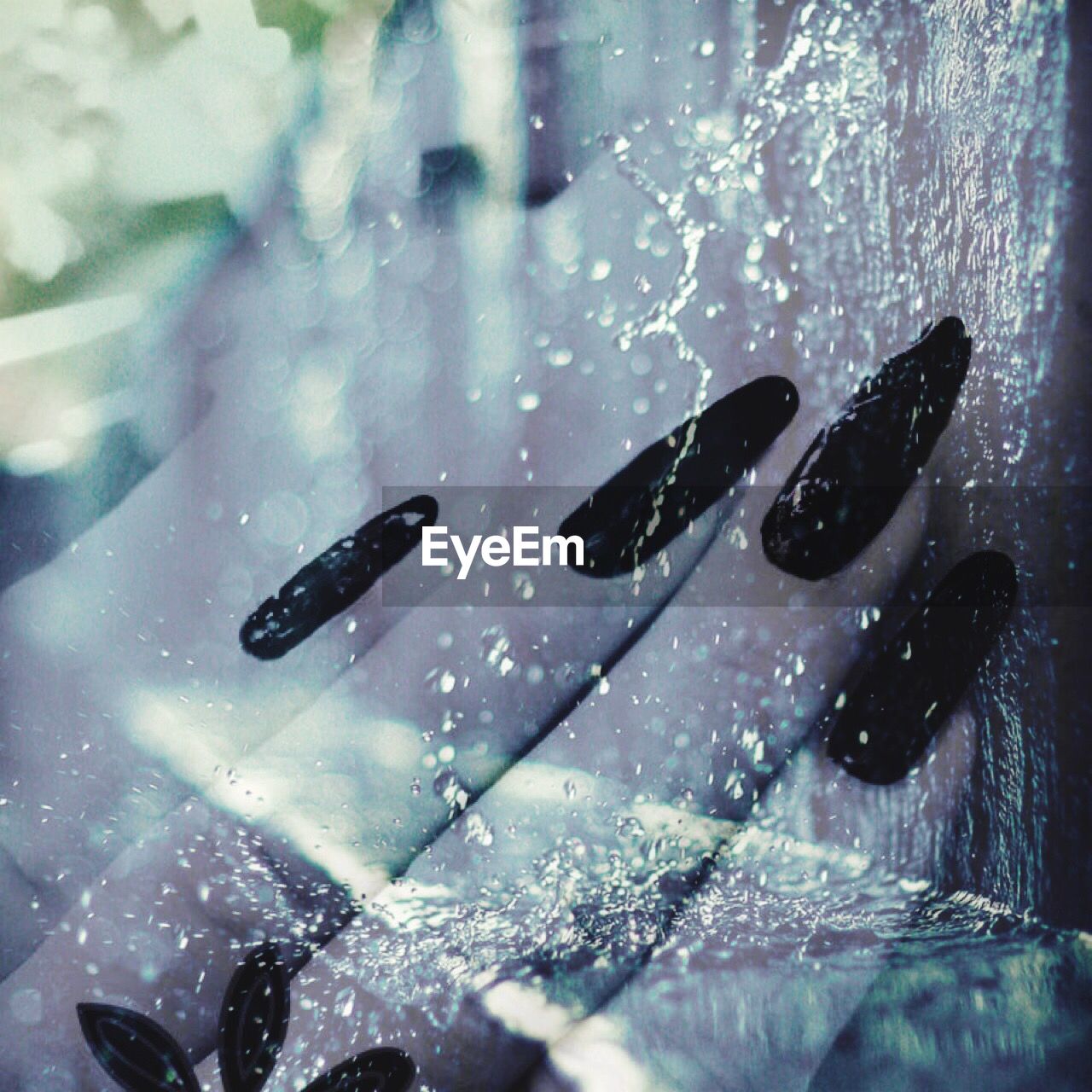 CLOSE-UP OF WATER DROPS ON SWIMMING IN POOL