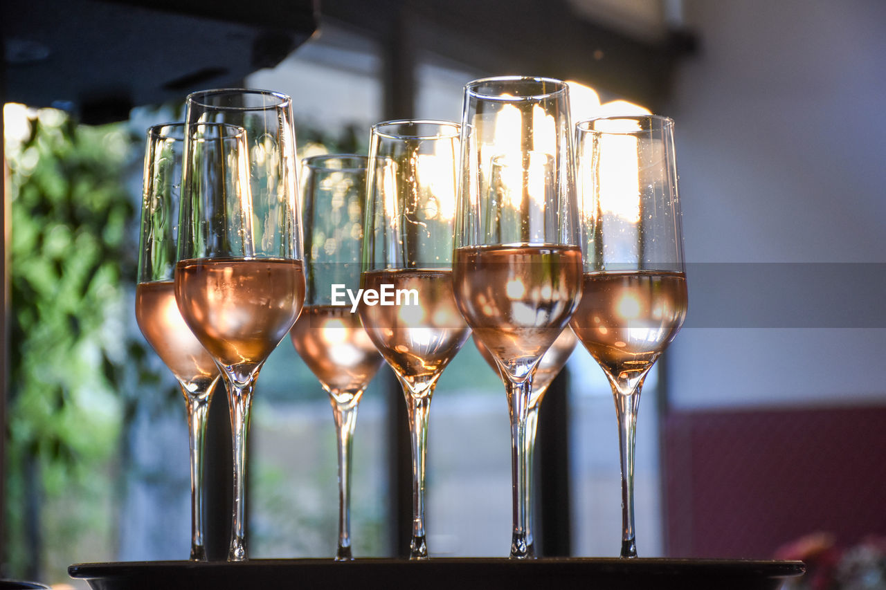 Close-up of wine glasses on table