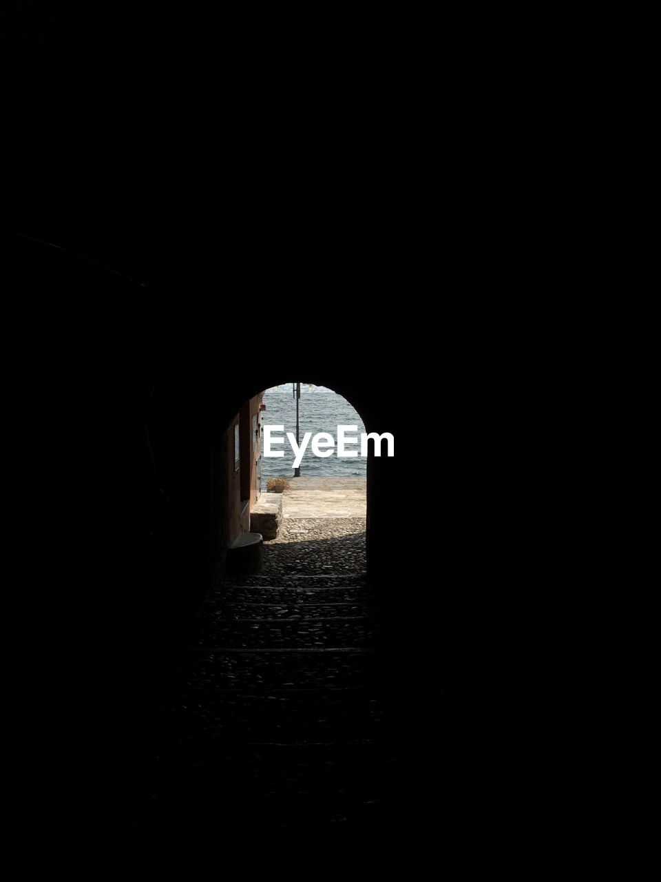 View of archway and sea seen through tunnel