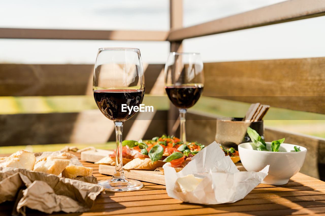 Antipasto and red wine glasses on a table