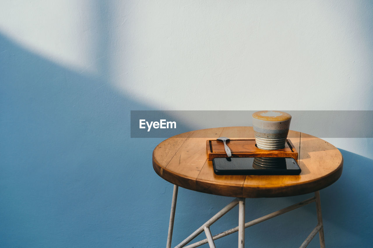 Coffee on table against wall