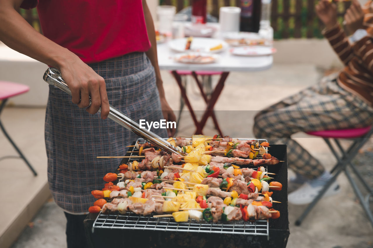 Man preparing food on barbecue grill