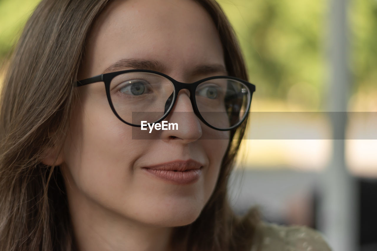 close-up of young woman wearing eyeglasses