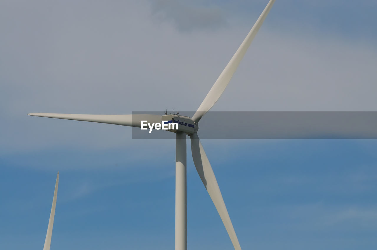 LOW ANGLE VIEW OF WINDMILLS AGAINST SKY