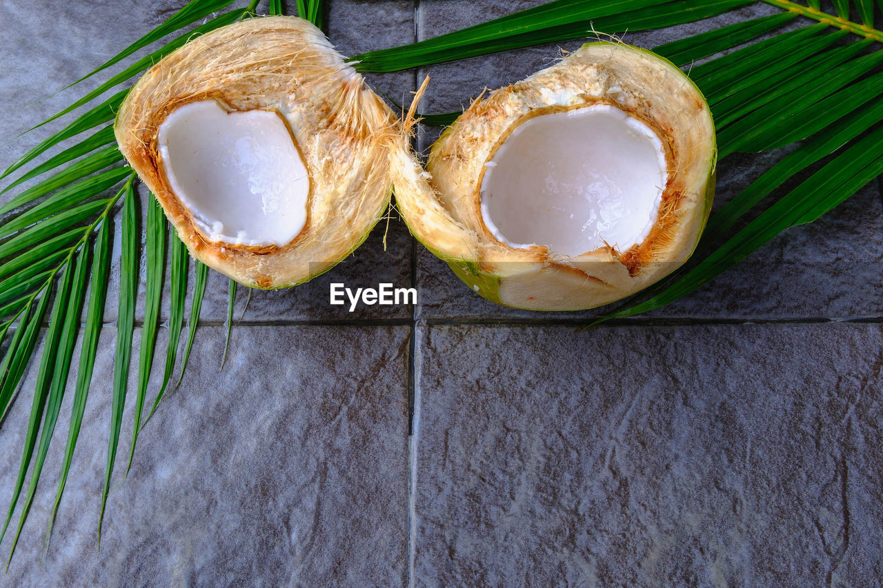 food and drink, food, plant, healthy eating, freshness, wellbeing, produce, fruit, high angle view, no people, leaf, still life, coconut, plant part, indoors, directly above, table, wood, green, close-up, slice, tropical fruit