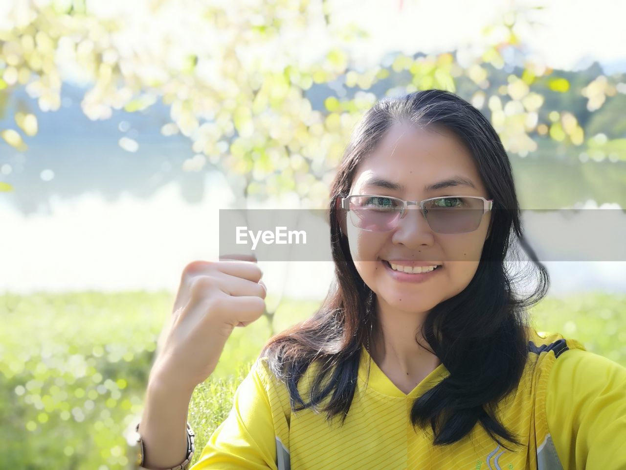 Portrait of smiling woman at park