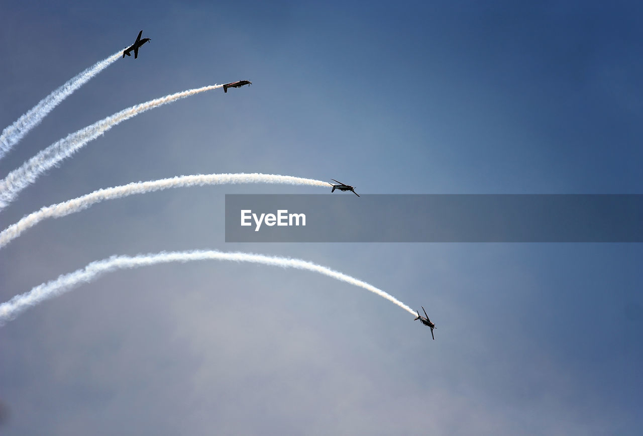 Low angle view of airplane flying against sky