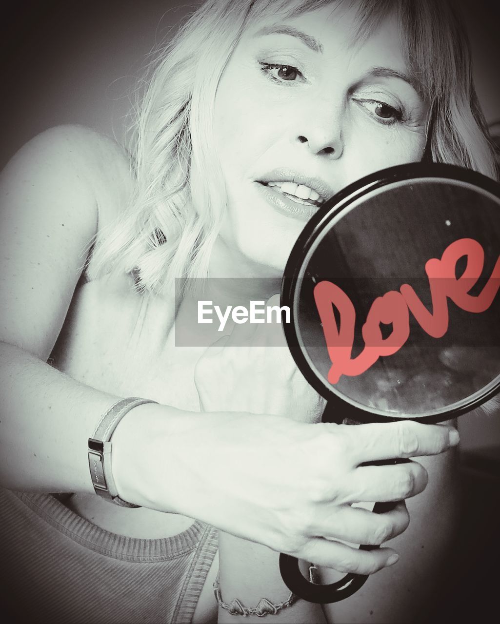 one person, women, white, portrait, person, adult, portrait photography, emotion, looking at camera, holding, indoors, black, female, human face, communication, child, monochrome, monochrome photography, black and white, clothing, childhood, sign, heart shape, human head, blond hair, front view, smiling, young adult, positive emotion, human eye, lifestyles, food and drink, photo shoot, hairstyle, waist up