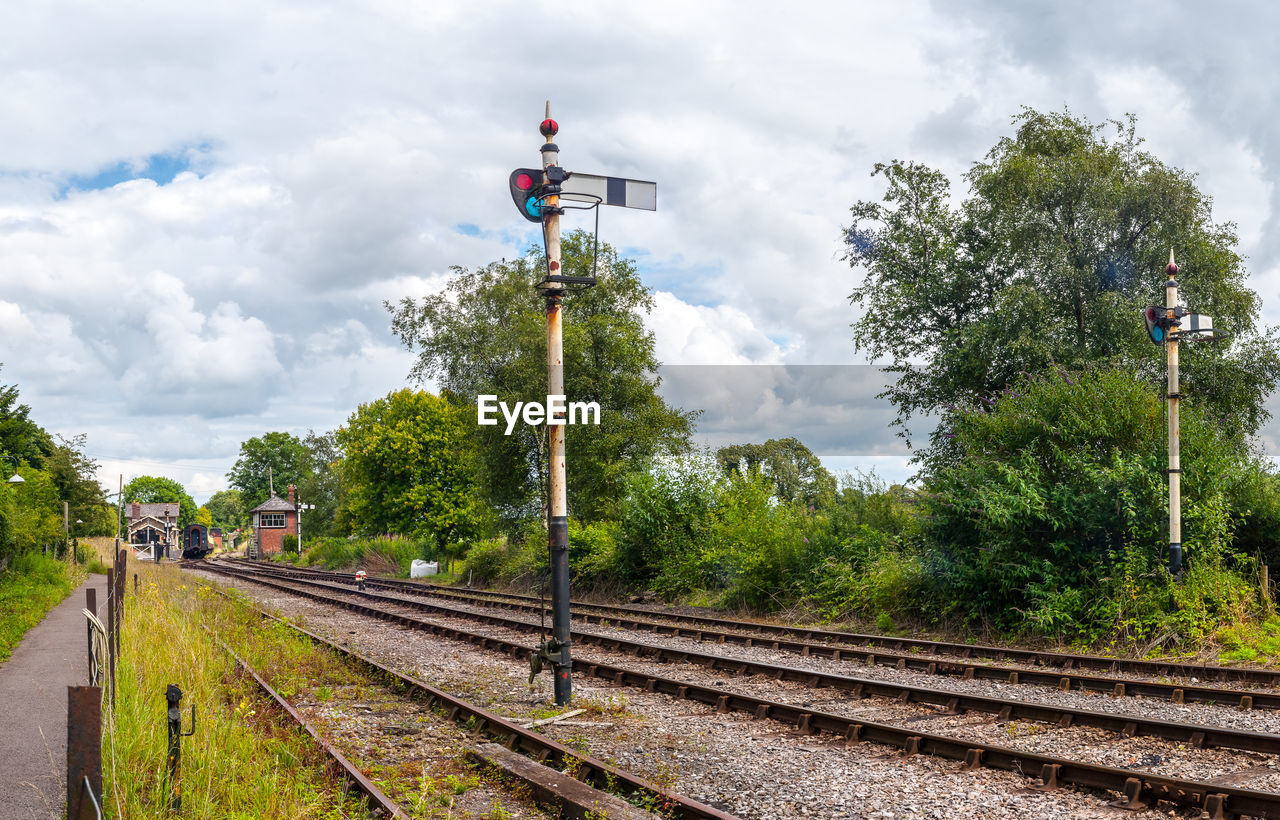 TRAIN ON RAILROAD TRACK AGAINST SKY