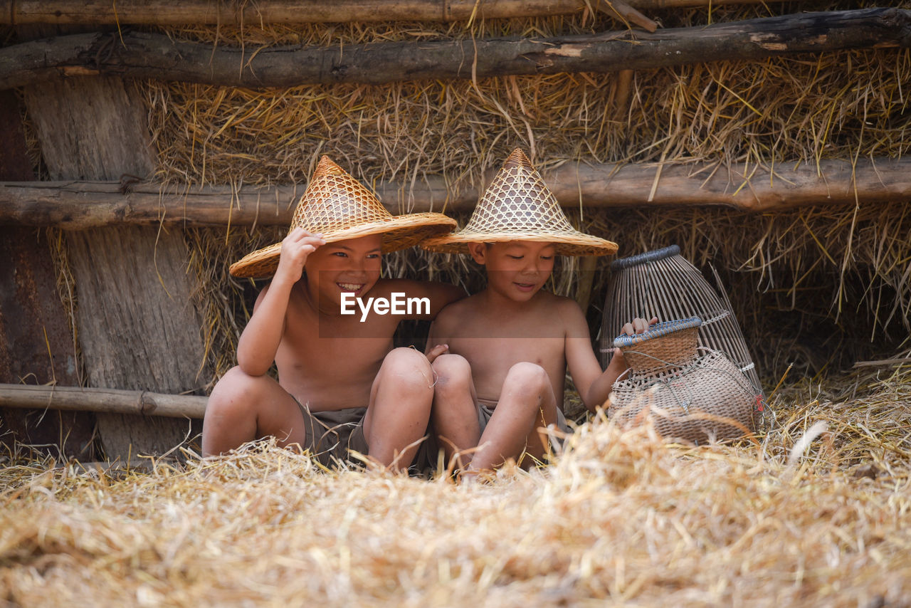 Boys sitting on hay