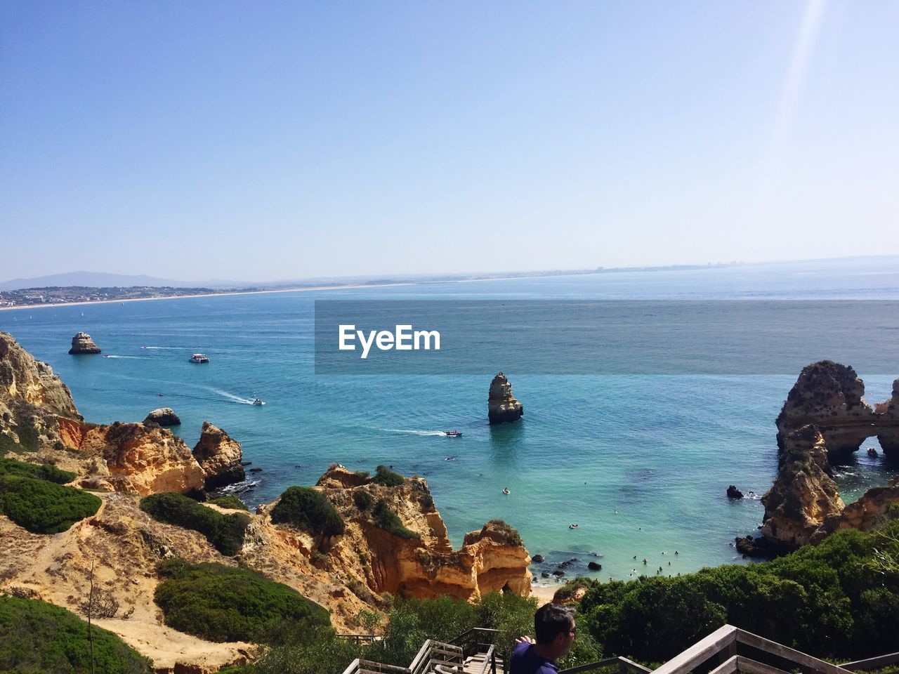 Scenic view of sea against clear blue sky