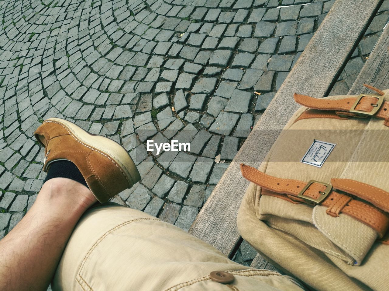 LOW SECTION OF MAN WEARING SHOES ON GROUND