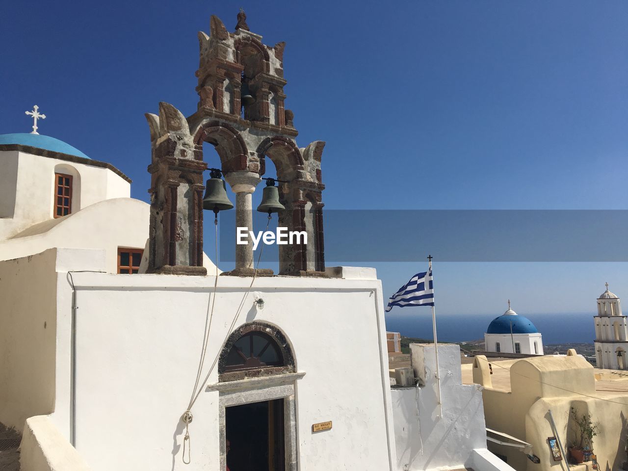 Built structure in city against blue sky