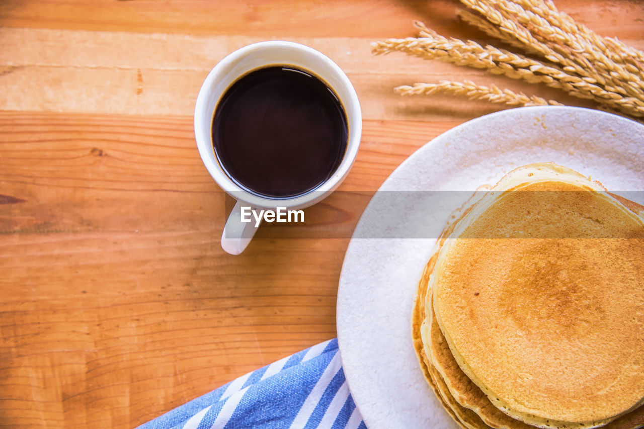 High angle view of pancakes with coffee on table