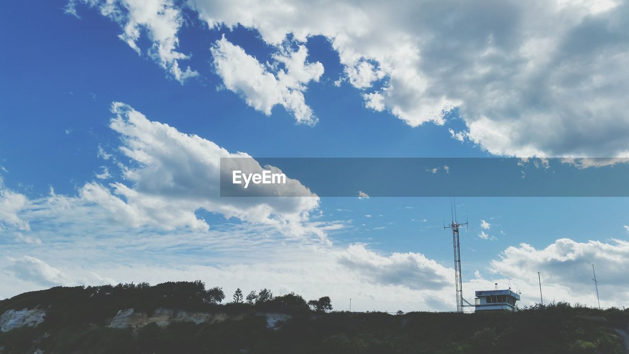 Low angle view of communications tower against sky