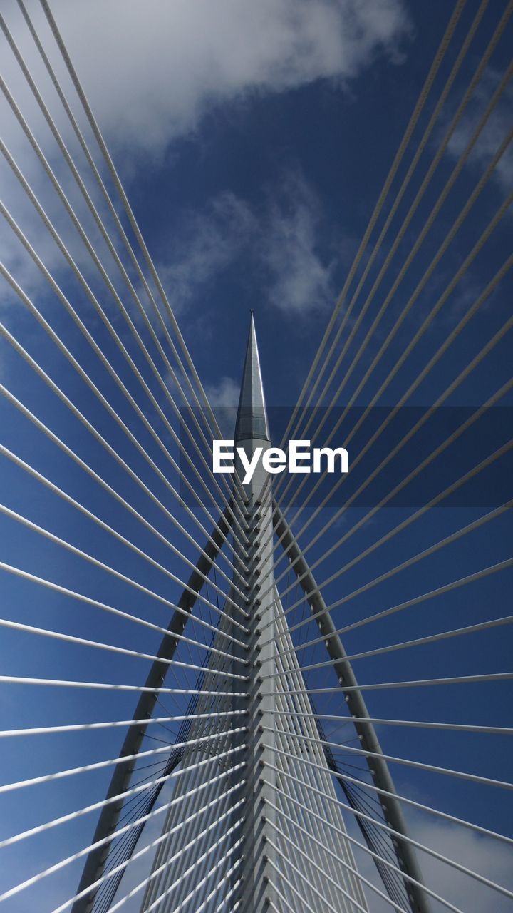 Low angle view of suspension bridge against sky