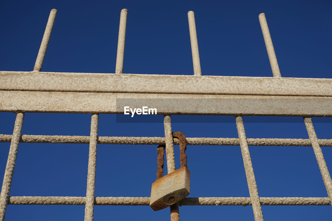 blue, sky, clear sky, metal, no people, architecture, protection, security, line, day, nature, fence, low angle view, outdoor structure, wall, outdoors, built structure