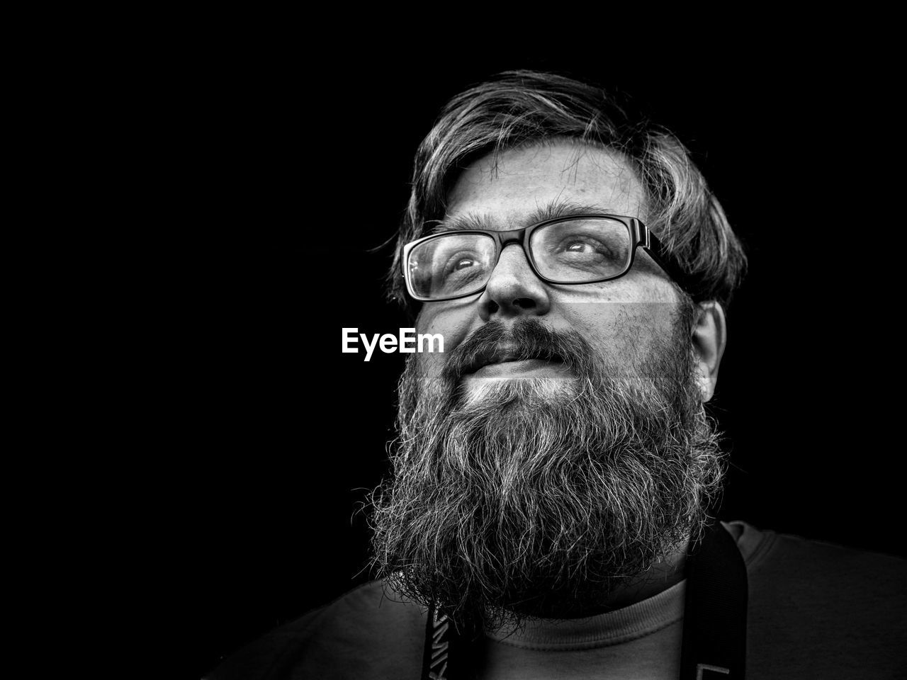 Portrait of man against black background