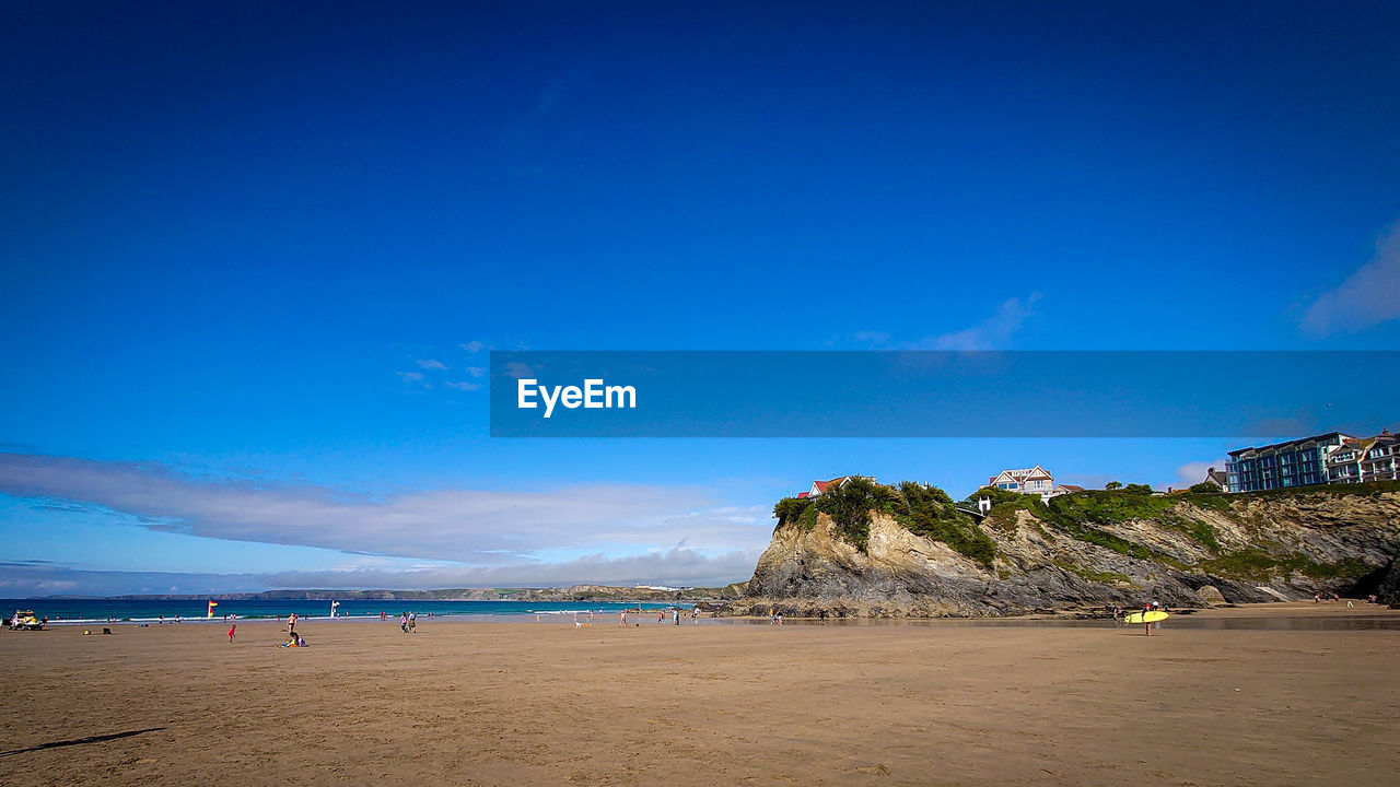 Scenic view of beach against blue sky