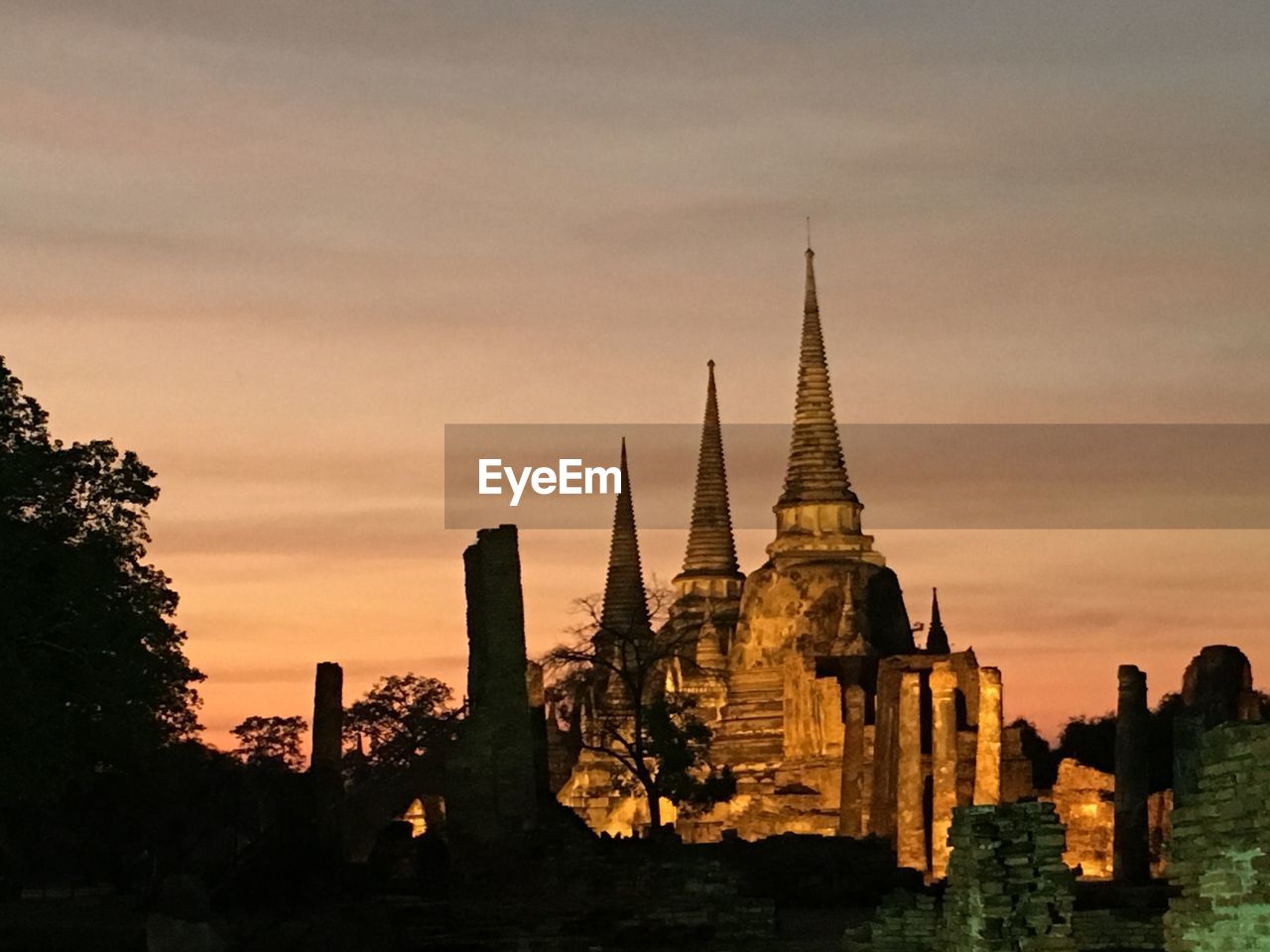 Low angle view of historic temple against sky during sunset