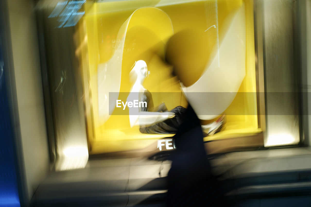 SIDE VIEW OF A WOMAN WALKING ON YELLOW