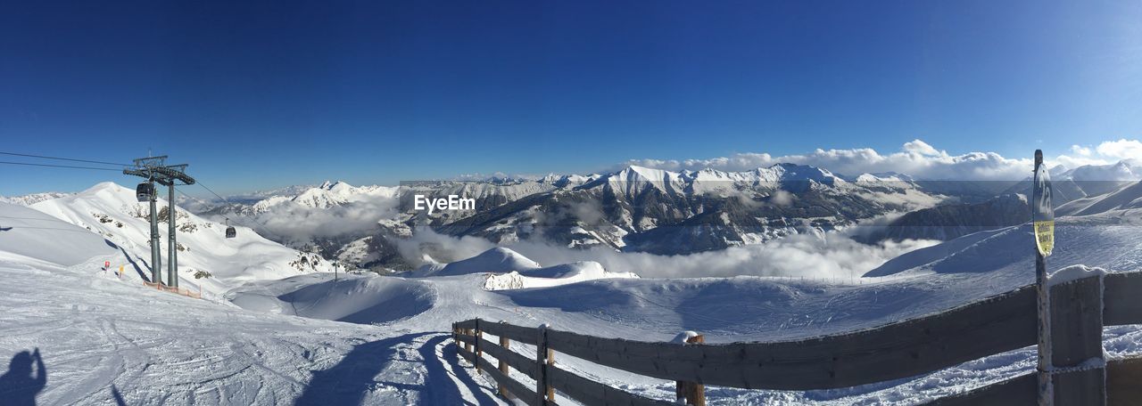 Scenic view of snow covered mountains against clear sky