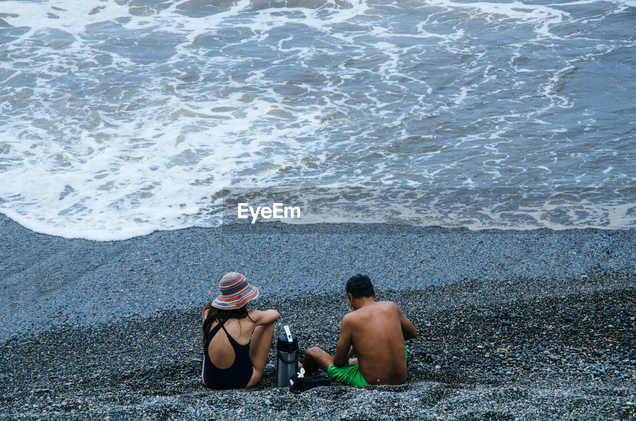 Couple sitting at beach