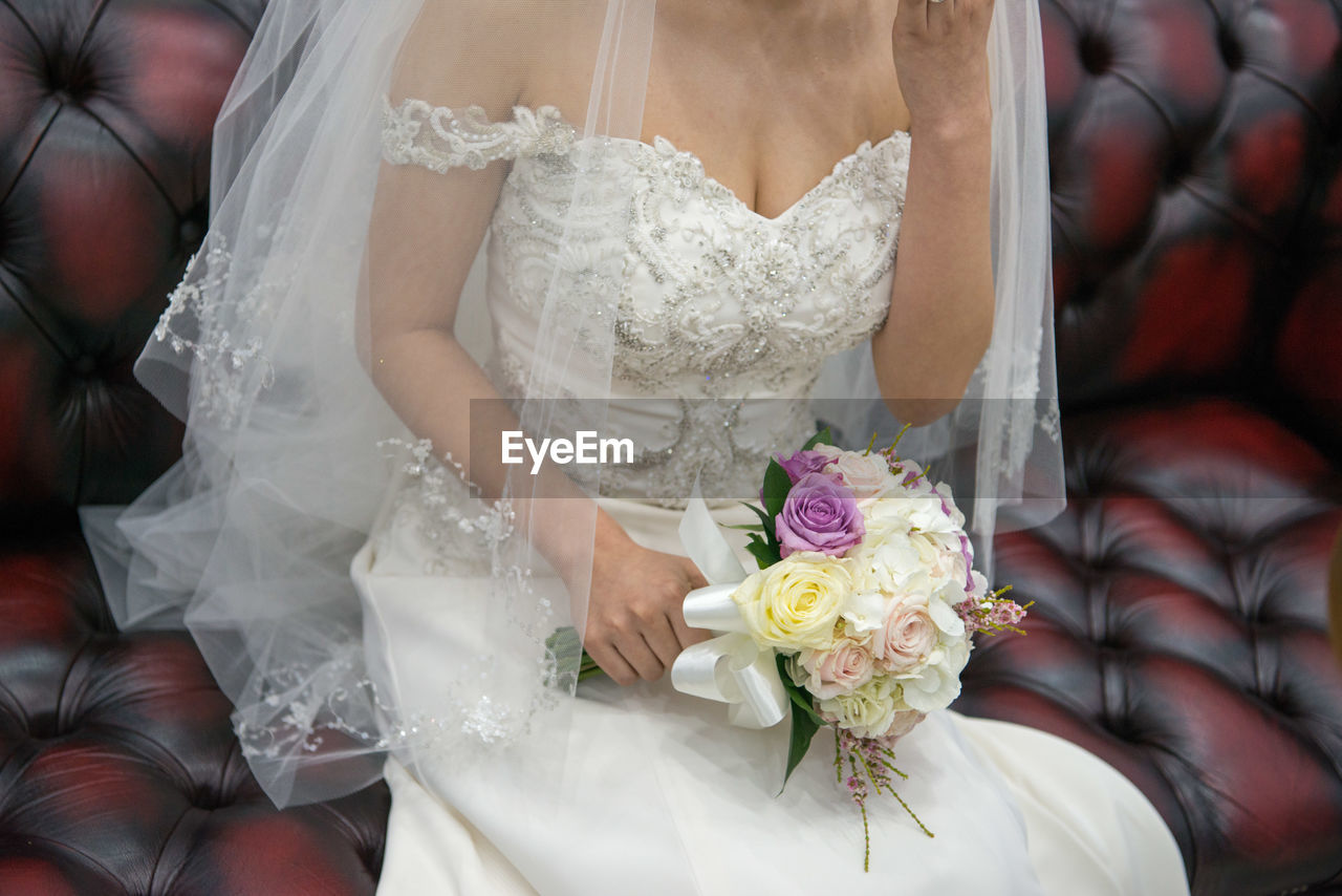 Close-up of woman holding bouquet