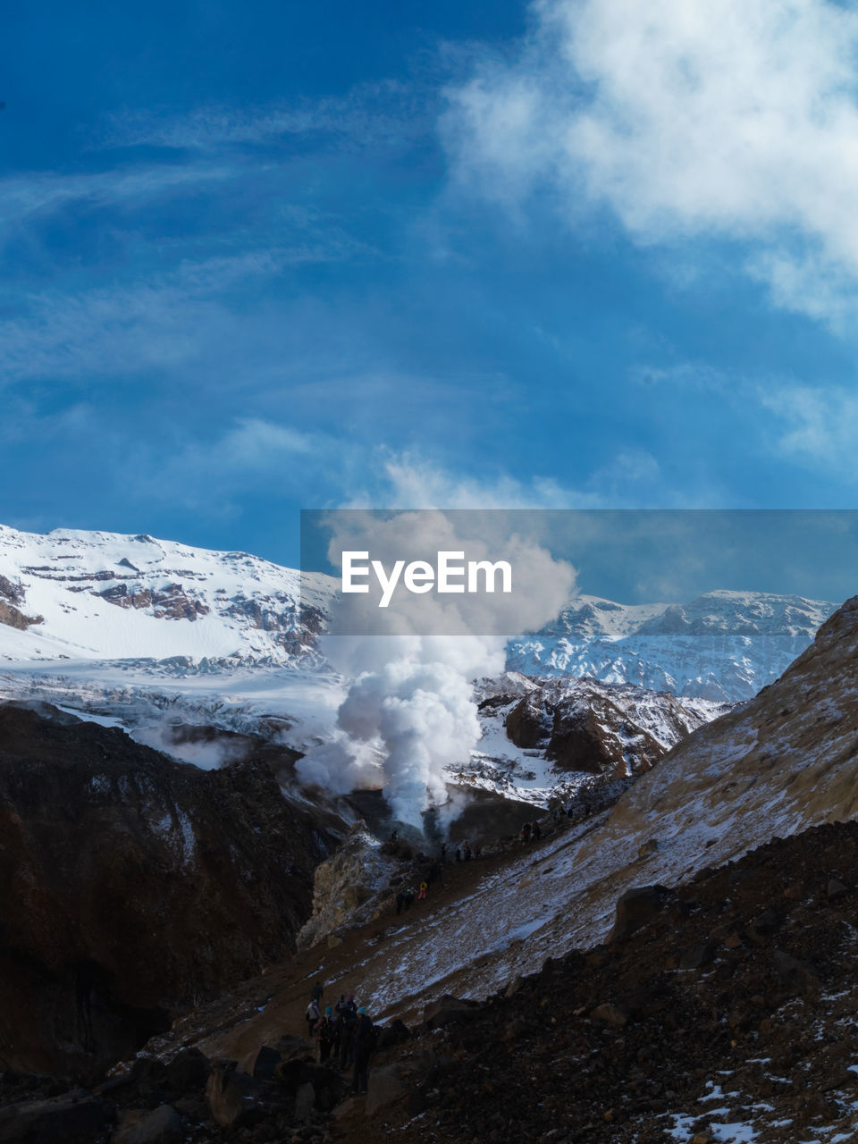 Aerial view of snowcapped mountains against sky