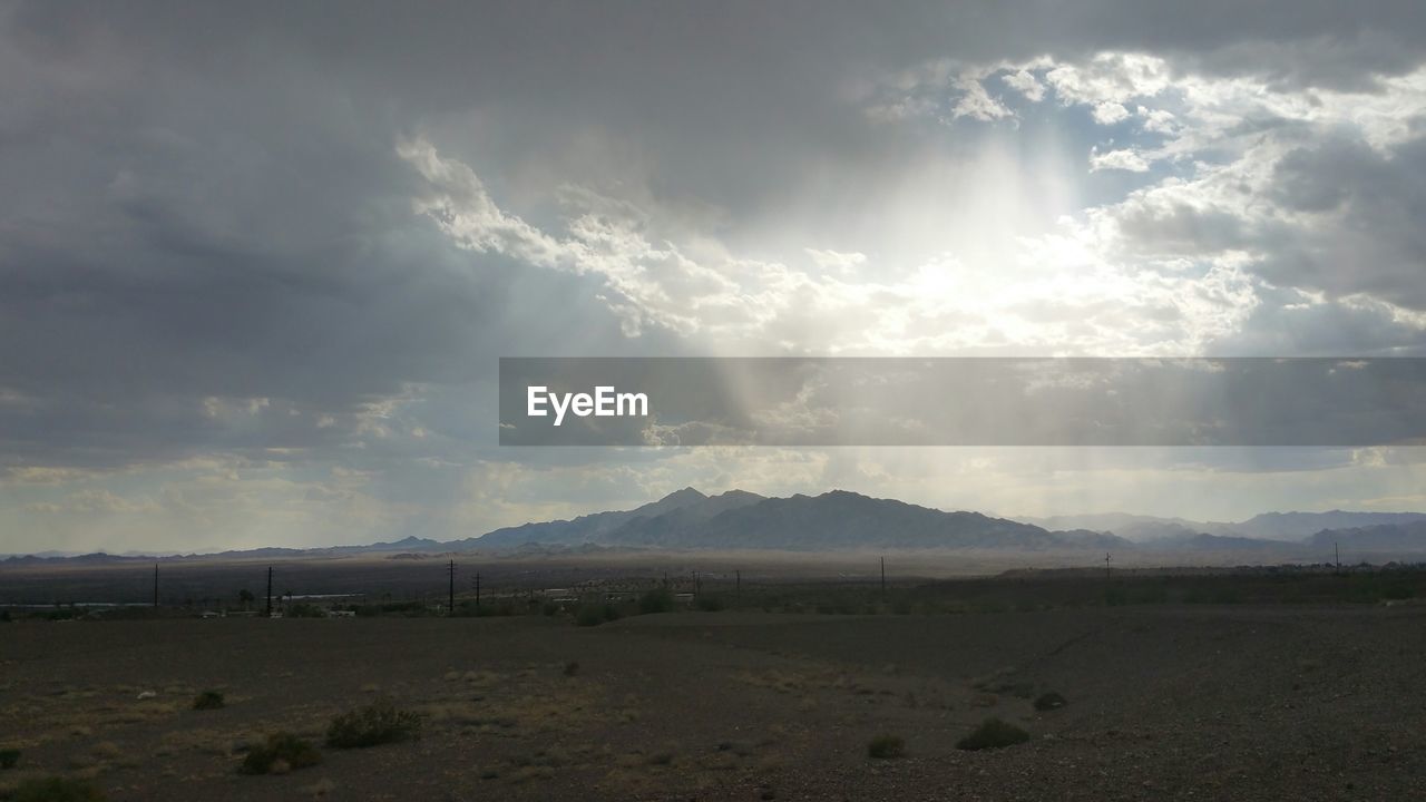 SCENIC VIEW OF MOUNTAINS AGAINST CLOUDY SKY