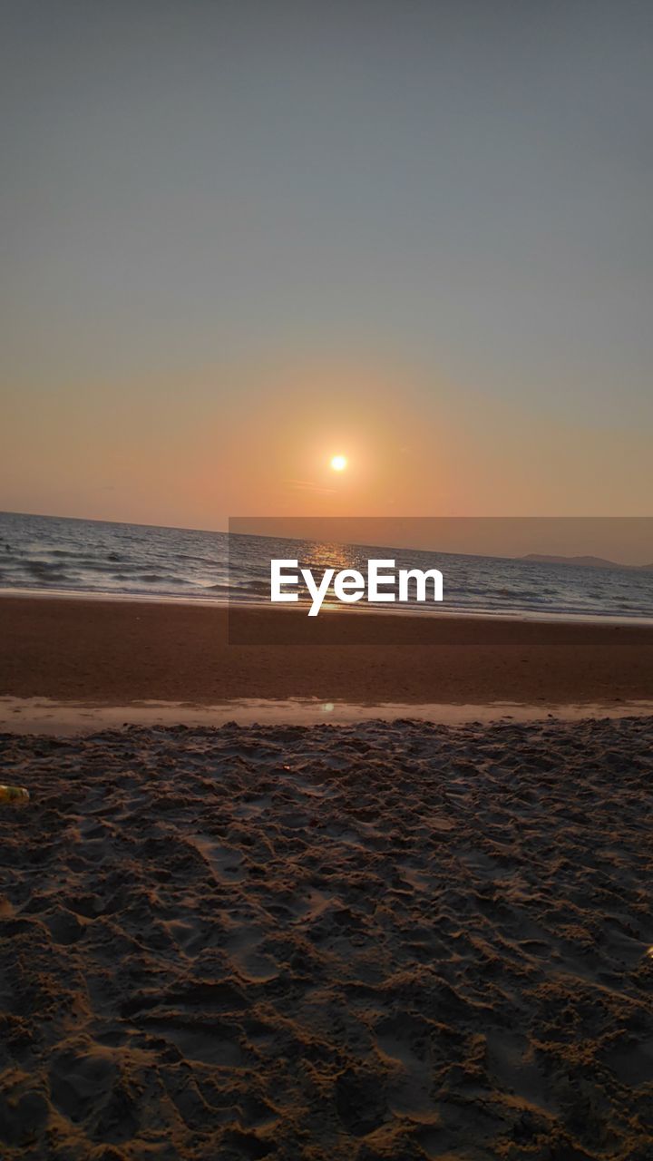 SCENIC VIEW OF BEACH DURING SUNSET