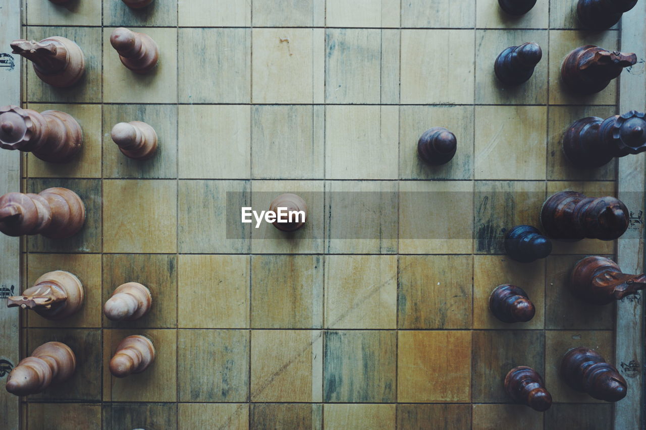 Directly above shot of wooden chess board with pieces