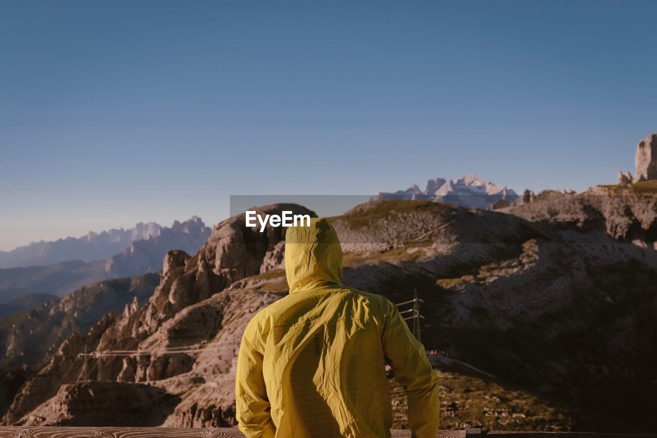 Rear view of person against mountains and sky