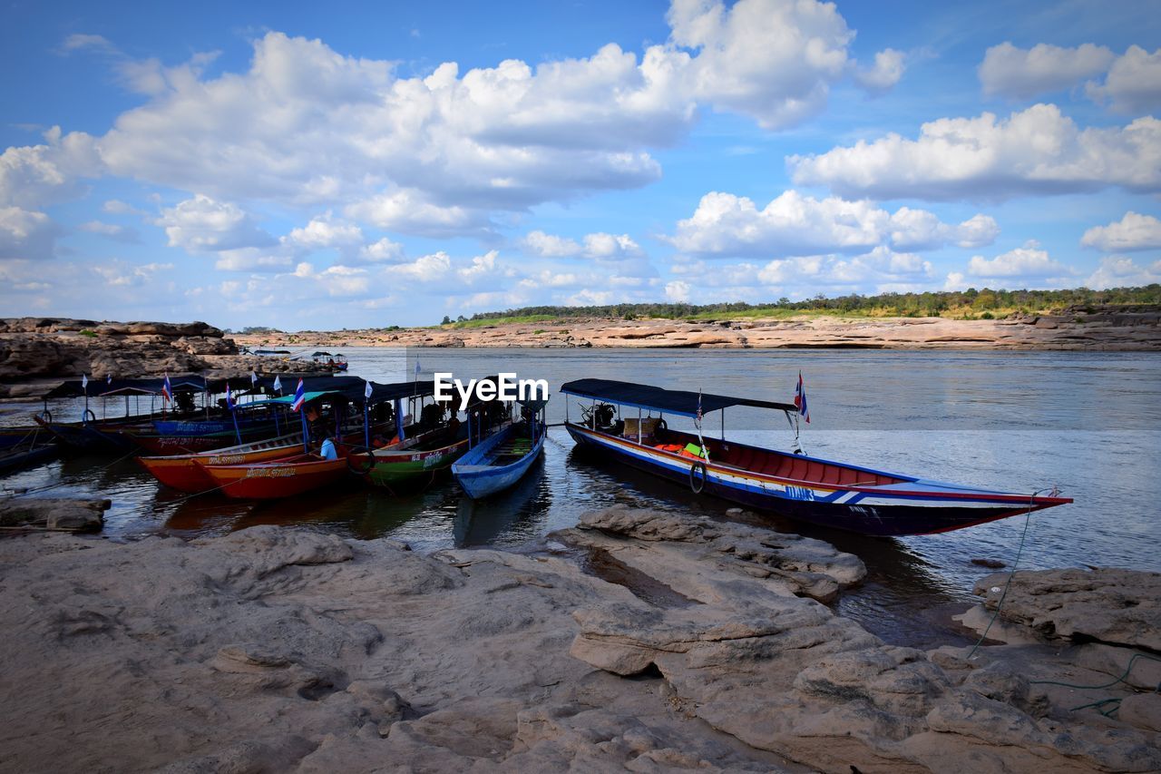 BOAT MOORED ON BEACH