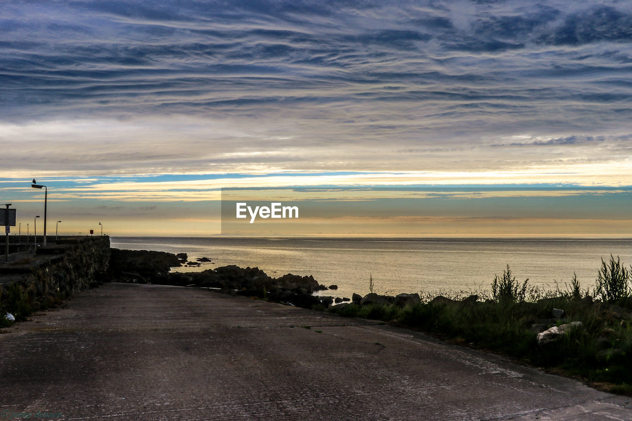 Scenic view of sea against cloudy sky