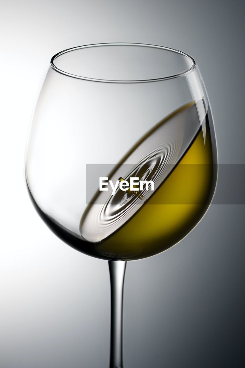 glass, wine glass, refreshment, drinking glass, drink, alcohol, stemware, household equipment, food and drink, studio shot, white wine, champagne stemware, drinkware, wine, transparent, no people, indoors, water, alcoholic beverage, single object, gray background, champagne, gray, food, cut out, reflection