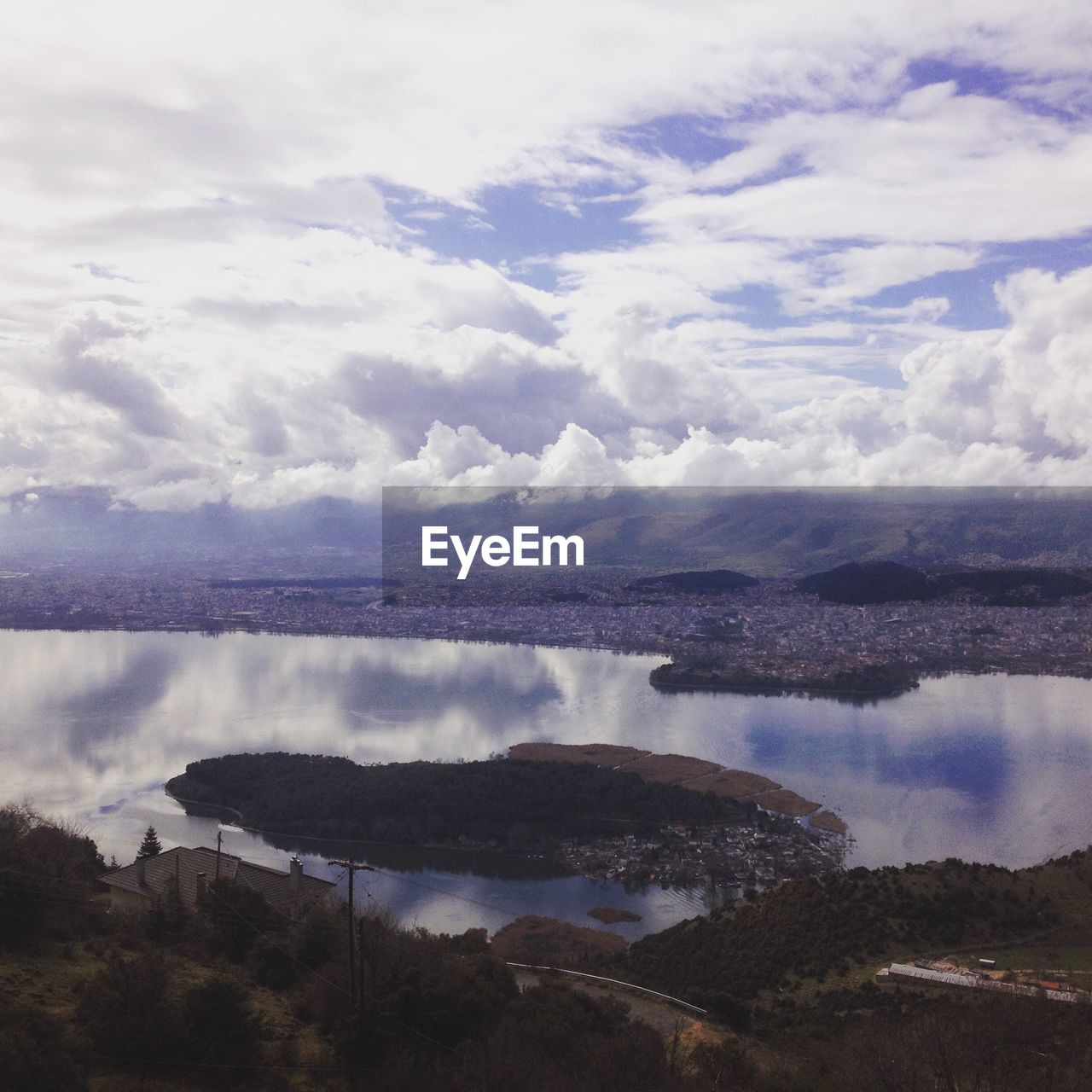 Scenic view of lake ioannina against cloudy sky