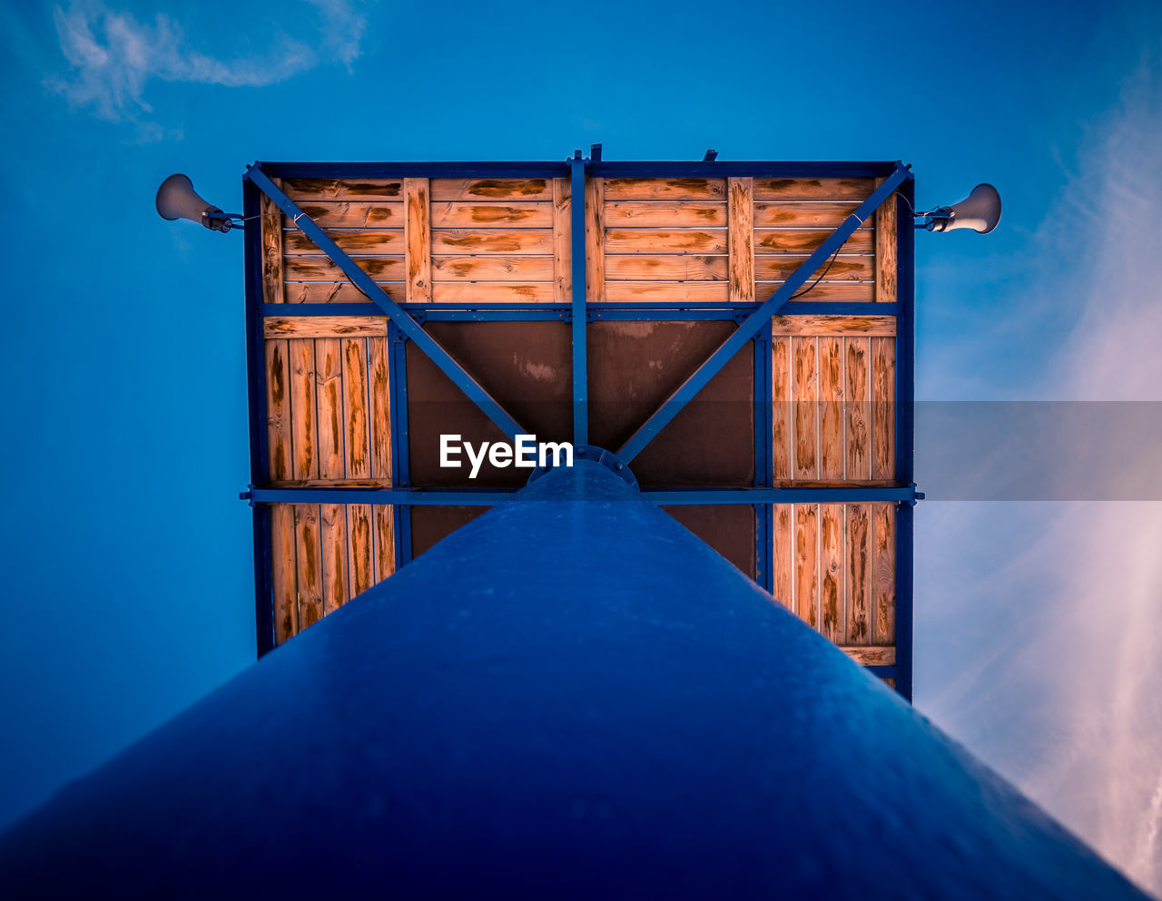 Close-up of wooden structure against blue sky