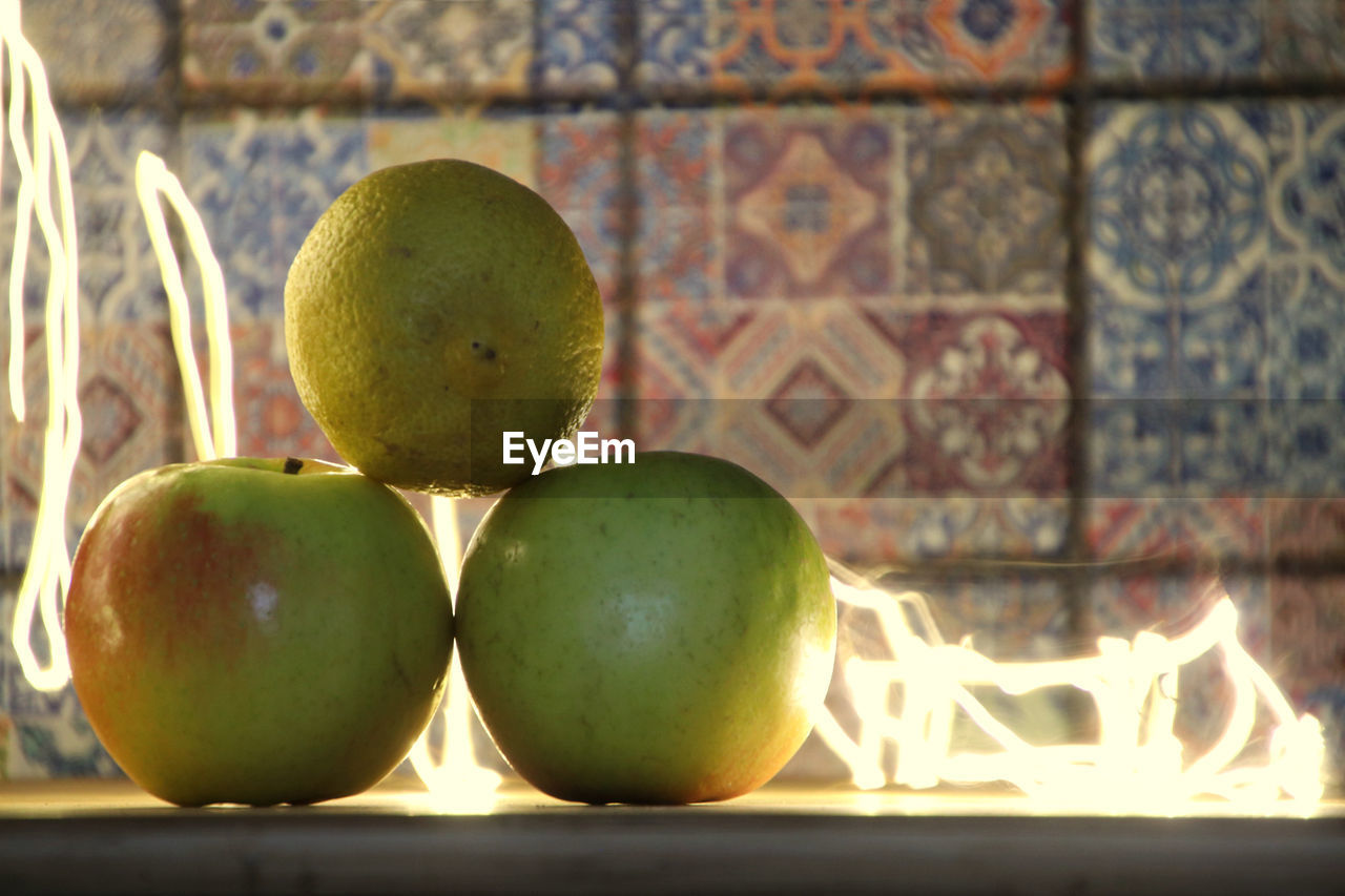 Close-up of illuminated apples