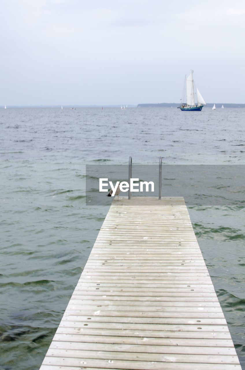 Pier over sea against sky