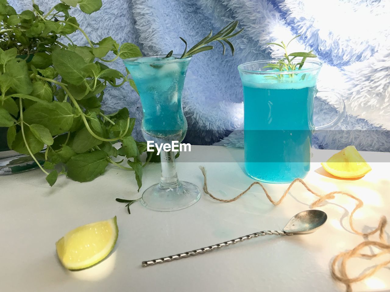 Blue cold drink in a glass with ice cubes