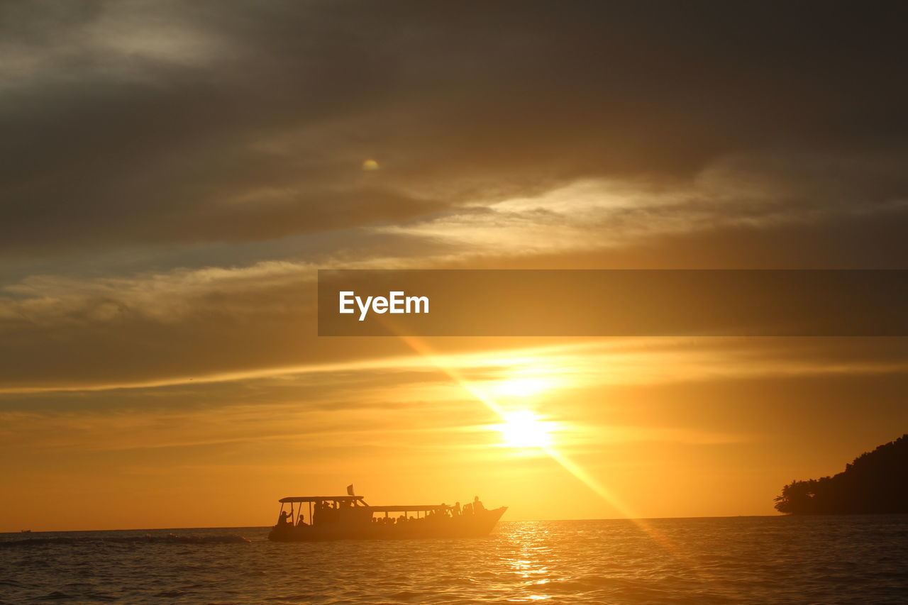 SILHOUETTE BOAT IN SEA AGAINST ORANGE SKY