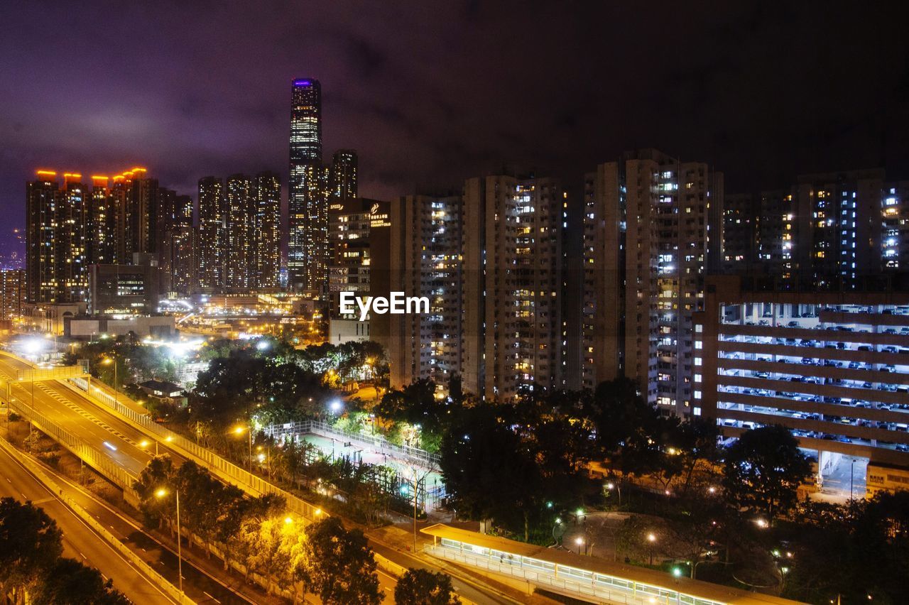 ILLUMINATED CITY BUILDINGS AT NIGHT