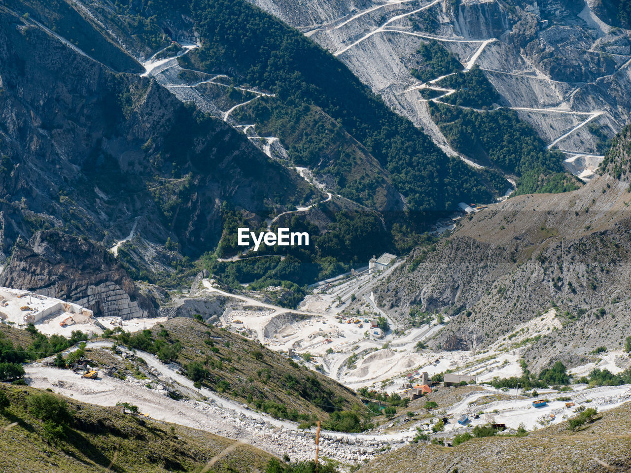 View of the carrara marble quarries and the transport trails carved into the side of the mountain.